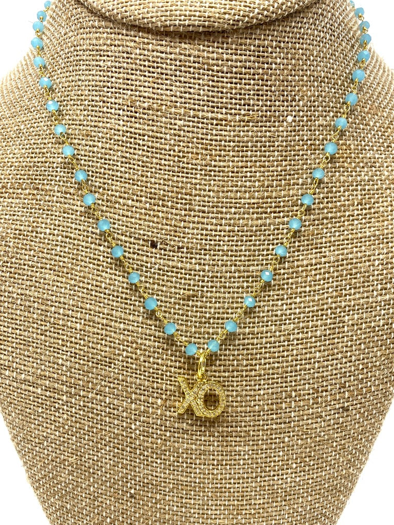 Turquoise Colored Rosary Style Necklace With Gold "XO" Pendant