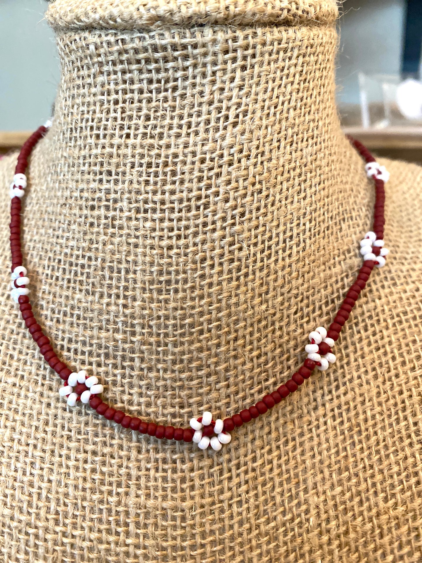 Tiny Opaque Maroon Beaded Daisy Chain Necklace With White Flowers.